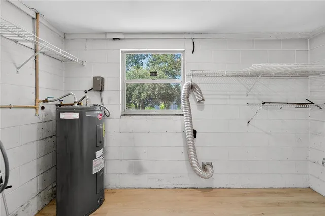 a view of a house with a yard and large tree