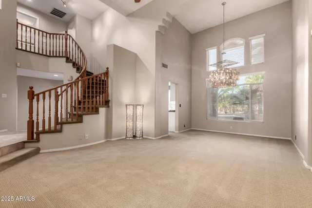 a living room with furniture a flat screen tv and a large window