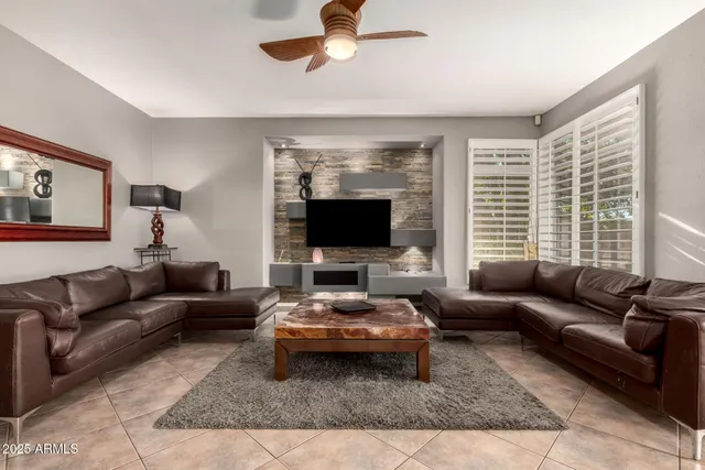 a kitchen with kitchen island granite countertop a refrigerator a stove top oven a sink and dishwasher