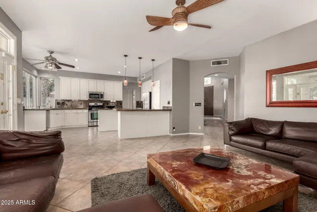 a kitchen with stainless steel appliances granite countertop a stove sink and microwave