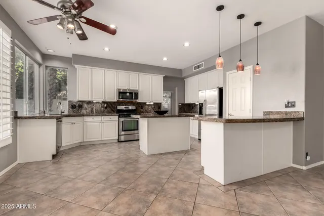 a kitchen with a stove a sink and a microwave