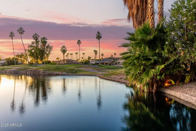 a view of a lake with houses in the back
