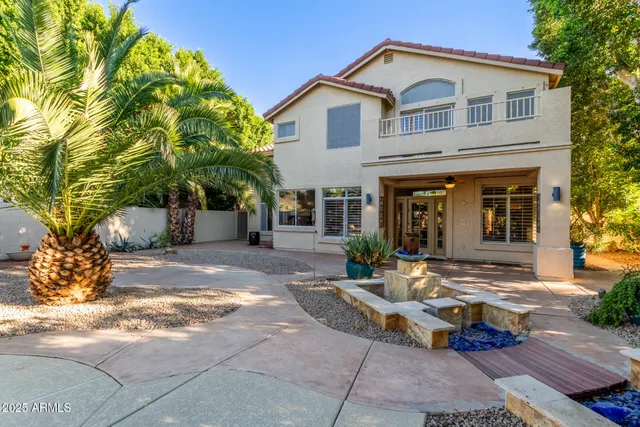 a view of a lake with a yard and a large tree