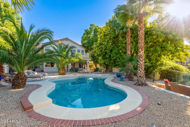 a view of a swimming pool with a table and chairs
