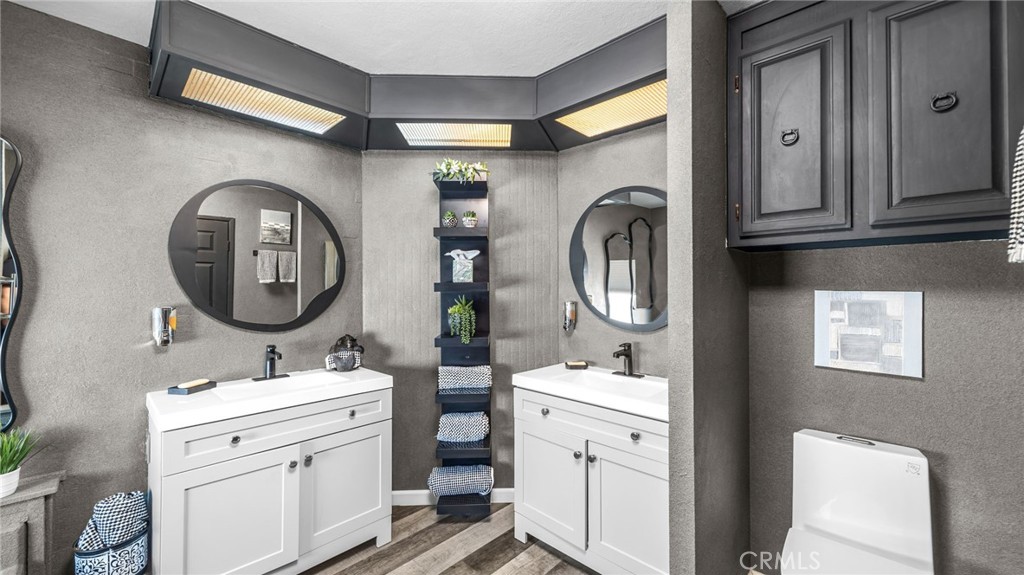 23301 Ridge Rte Drive, Unit 95 Laguna Hills, CA 92653 - Photo 14 of 35 a bathroom with a toilet sink and mirror