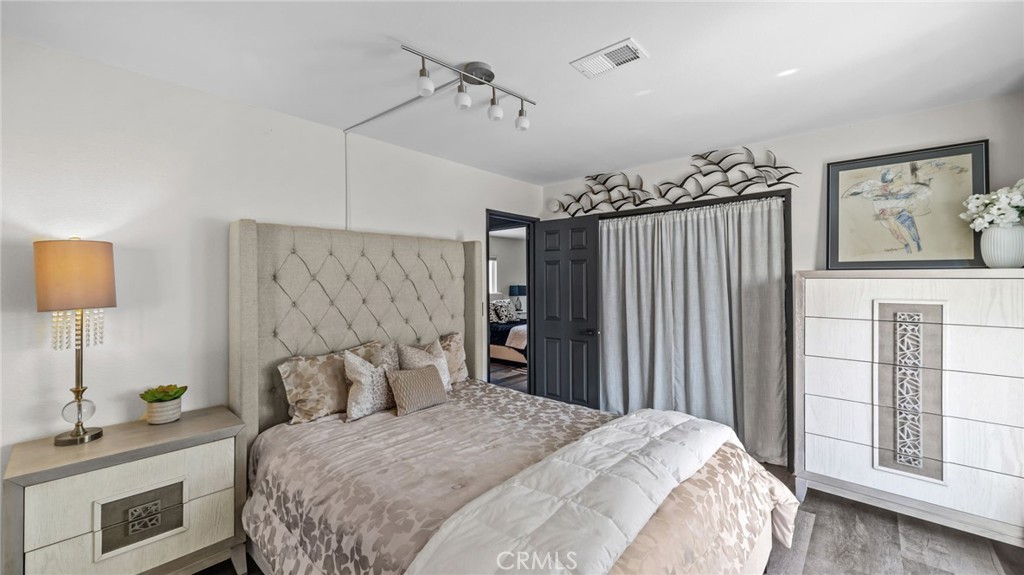 23301 Ridge Rte Drive, Unit 95 Laguna Hills, CA 92653 - Photo 15 of 35 a bedroom with a bed dresser and window