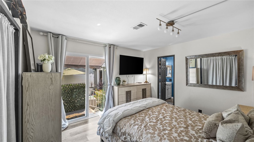 23301 Ridge Rte Drive, Unit 95 Laguna Hills, CA 92653 - Photo 16 of 35 a bedroom with a bed flat screen tv and a dresser