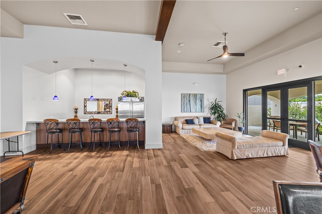 23301 Ridge Rte Drive, Unit 95 Laguna Hills, CA 92653 - Photo 29 of 35 a living room with furniture and a wooden floor