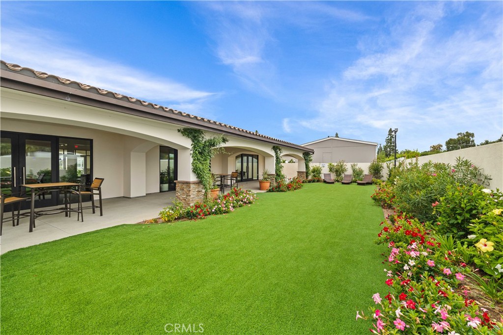 23301 Ridge Rte Drive, Unit 95 Laguna Hills, CA 92653 - Photo 32 of 35 a front view of house with a garden and patio