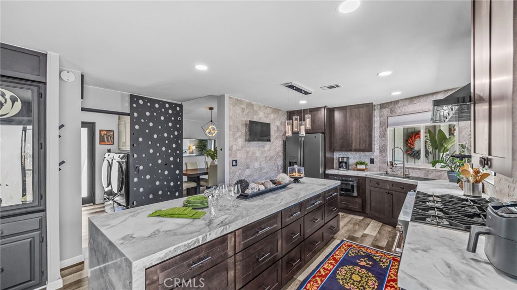 23301 Ridge Rte Drive, Unit 95 Laguna Hills, CA 92653 - Photo 4 of 35 a kitchen with stainless steel appliances granite countertop a sink stove and refrigerator
