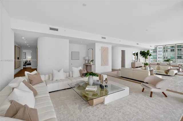 a living room with furniture a potted plant and a table