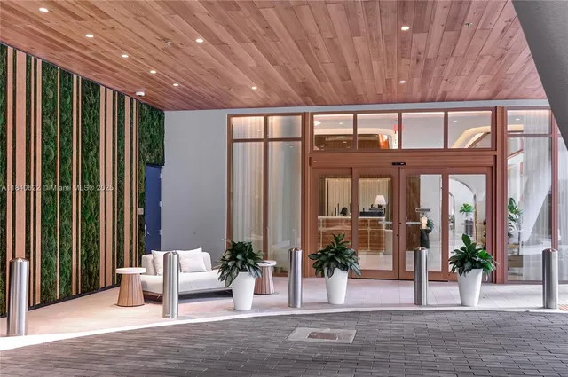 a living room with furniture and large windows