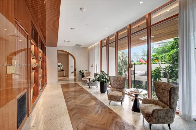 a living room with furniture and large windows