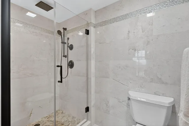 a spacious bathroom with a sink a toilet and shower