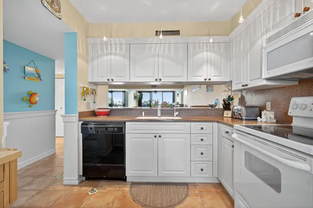 a view of a dining room with furniture and a kitchen