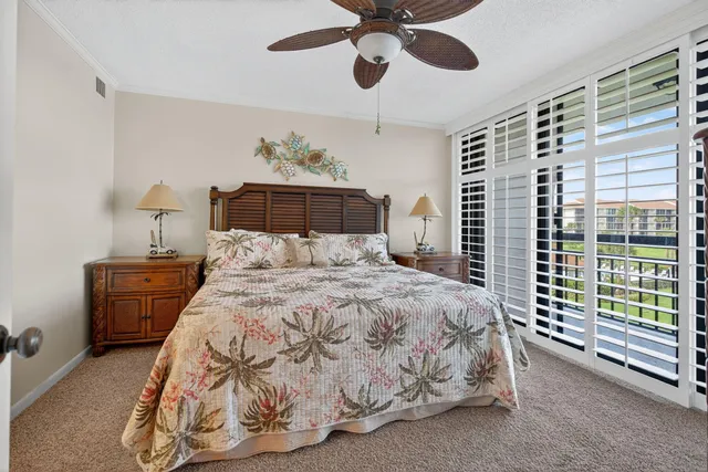 a bathroom with a granite countertop sink mirror and cabinets