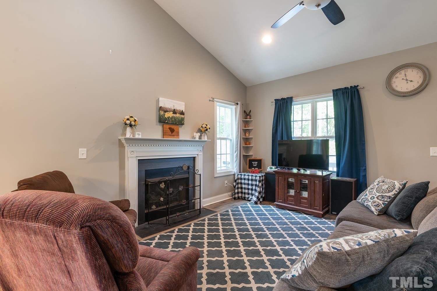 532 Cooper Street Clayton, NC 27520 - Photo 12 of 33 a living room with furniture and a fireplace