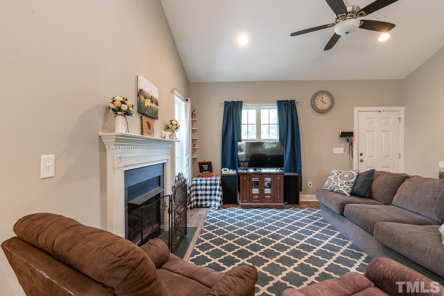 532 Cooper Street Clayton, NC 27520 - Photo 13 of 33 a living room with furniture and a fireplace