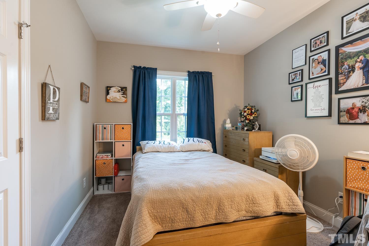 532 Cooper Street Clayton, NC 27520 - Photo 23 of 33 a bedroom with a bed and wooden floor