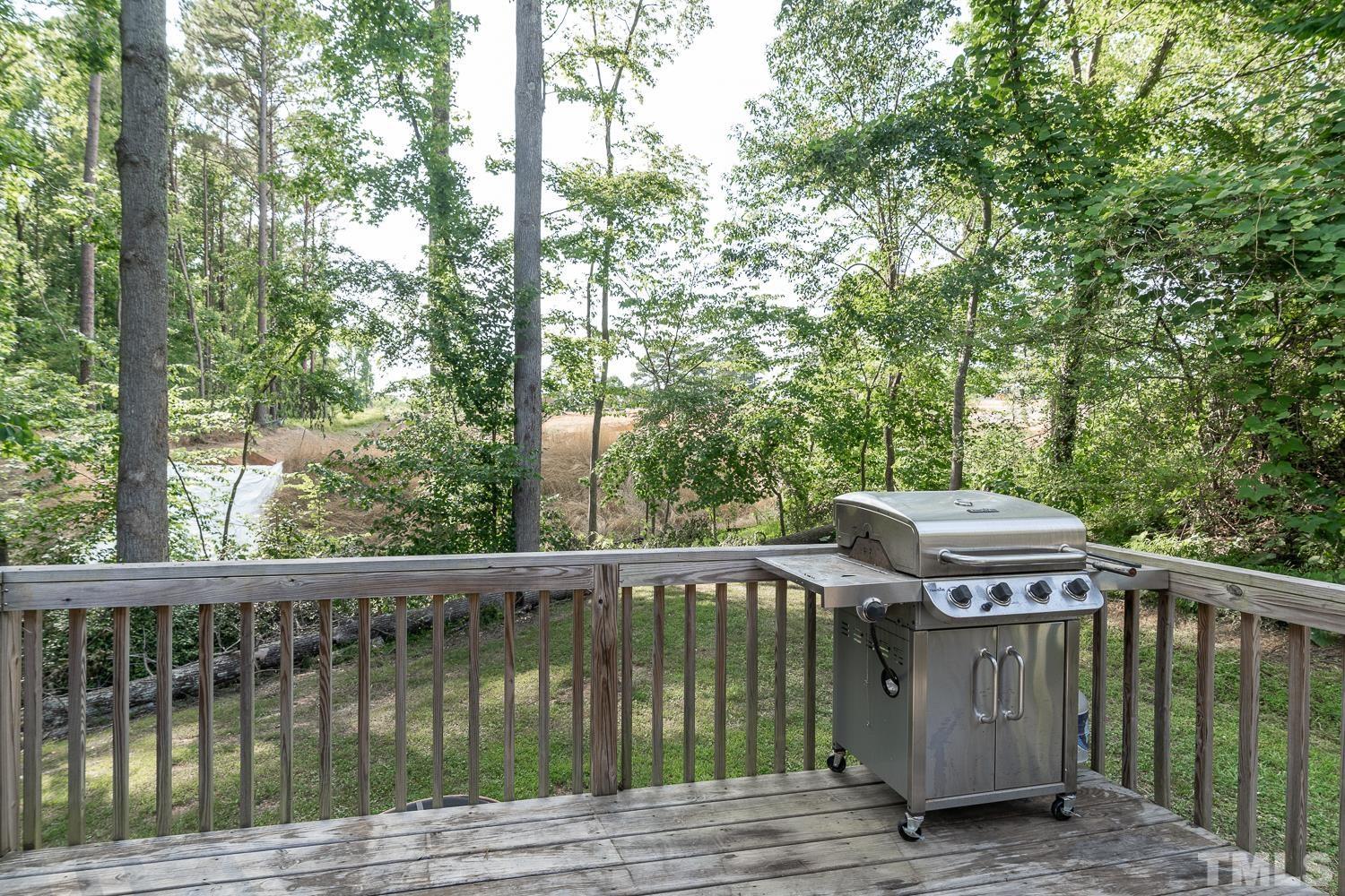 532 Cooper Street Clayton, NC 27520 - Photo 30 of 33 a view of a wooden deck next to a yard
