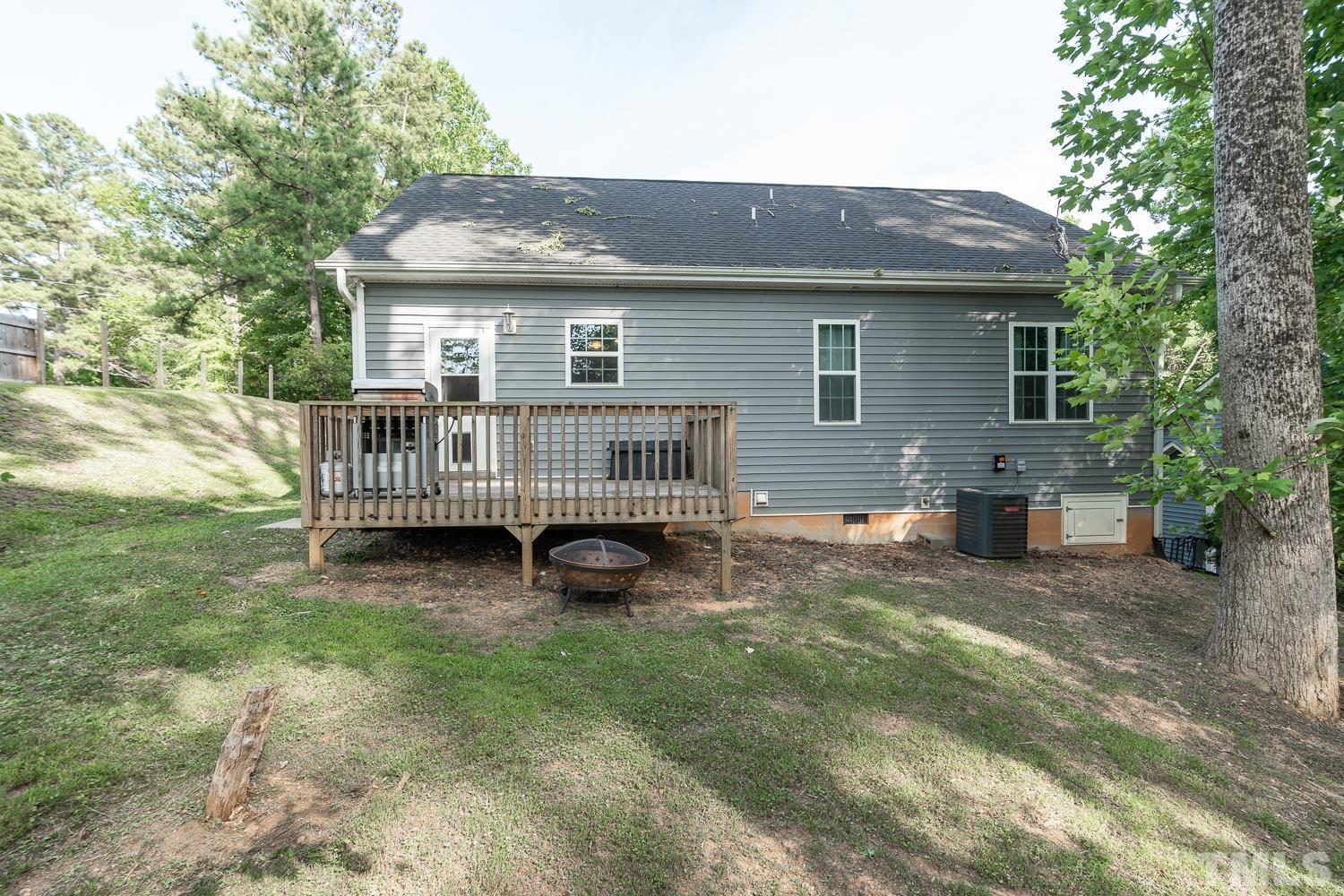 532 Cooper Street Clayton, NC 27520 - Photo 33 of 33 a view of house with a yard and deck