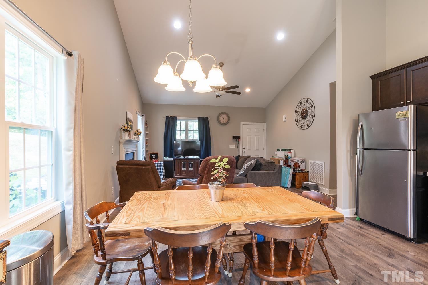 532 Cooper Street Clayton, NC 27520 - Photo 10 of 33 a view of a dining room with furniture a chandelier and wooden floor