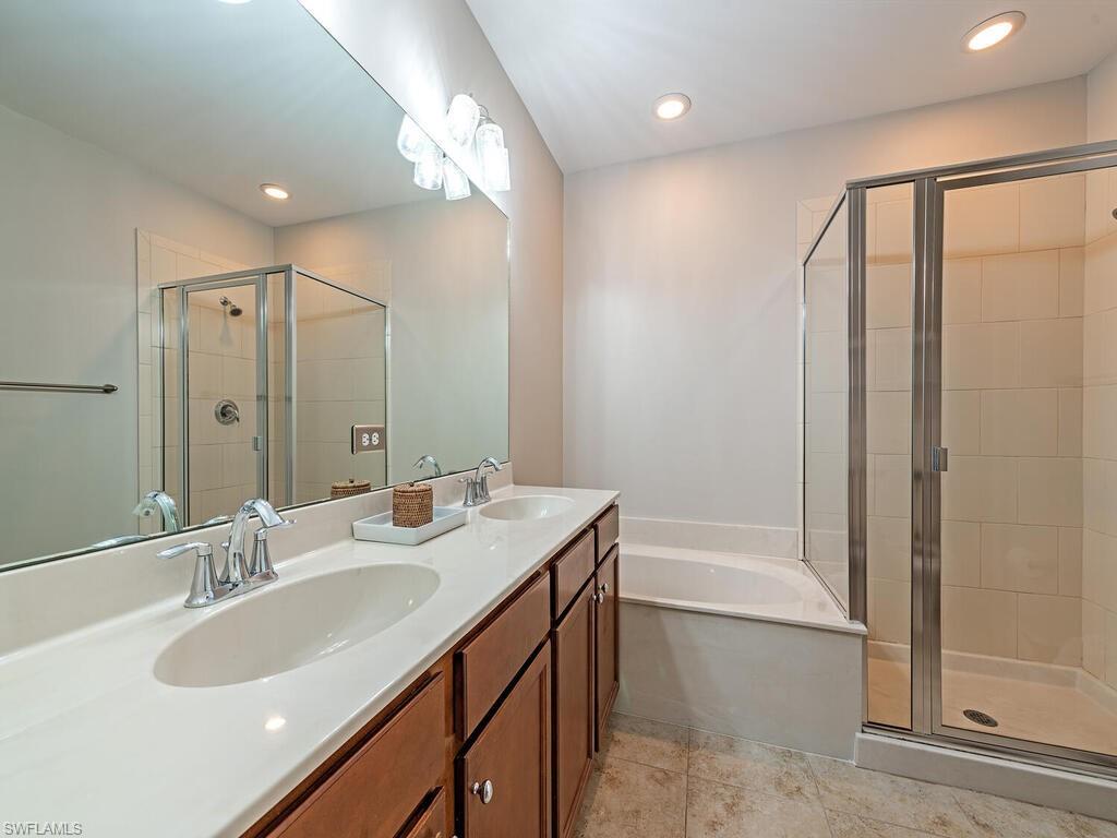 7777 Bristol Circle Naples, FL 34120 - Photo 11 of 22 a bathroom with a double vanity sink mirror double and a bathtub