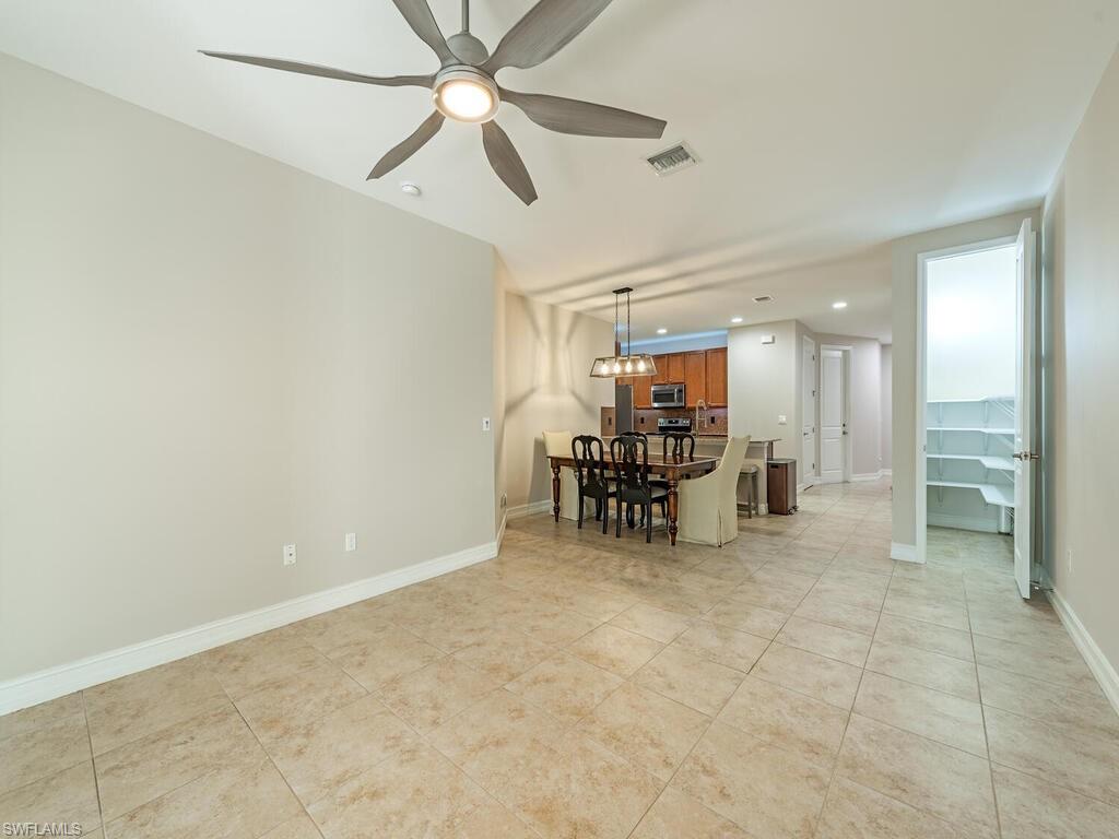 7777 Bristol Circle Naples, FL 34120 - Photo 4 of 22 a view of a livingroom with furniture and a ceiling fan