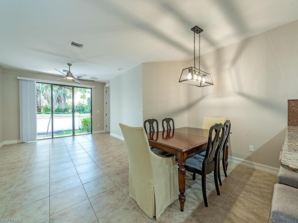 7777 Bristol Circle Naples, FL 34120 - Photo 5 of 22 a view of a dining room with furniture window and wooden floor