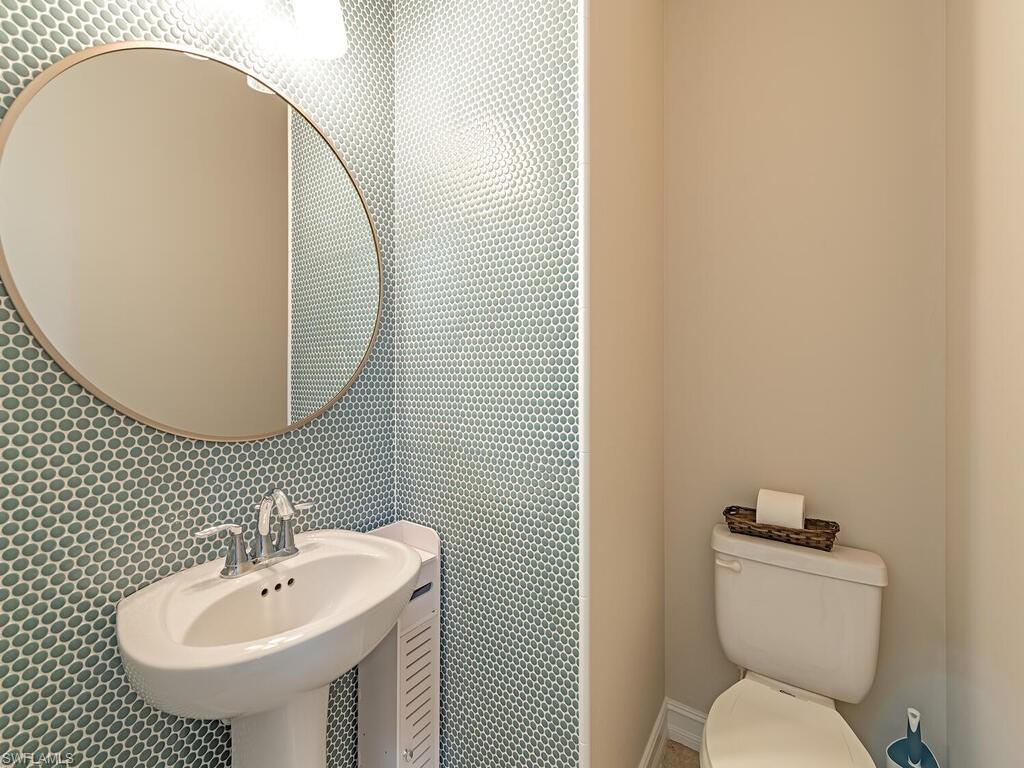 7777 Bristol Circle Naples, FL 34120 - Photo 7 of 22 a bathroom with a toilet sink and mirror