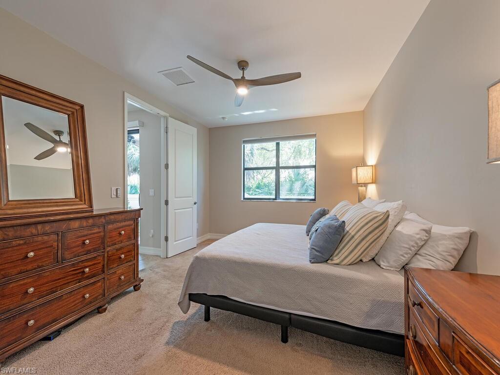 7777 Bristol Circle Naples, FL 34120 - Photo 10 of 22 a bedroom with a bed and a dresser