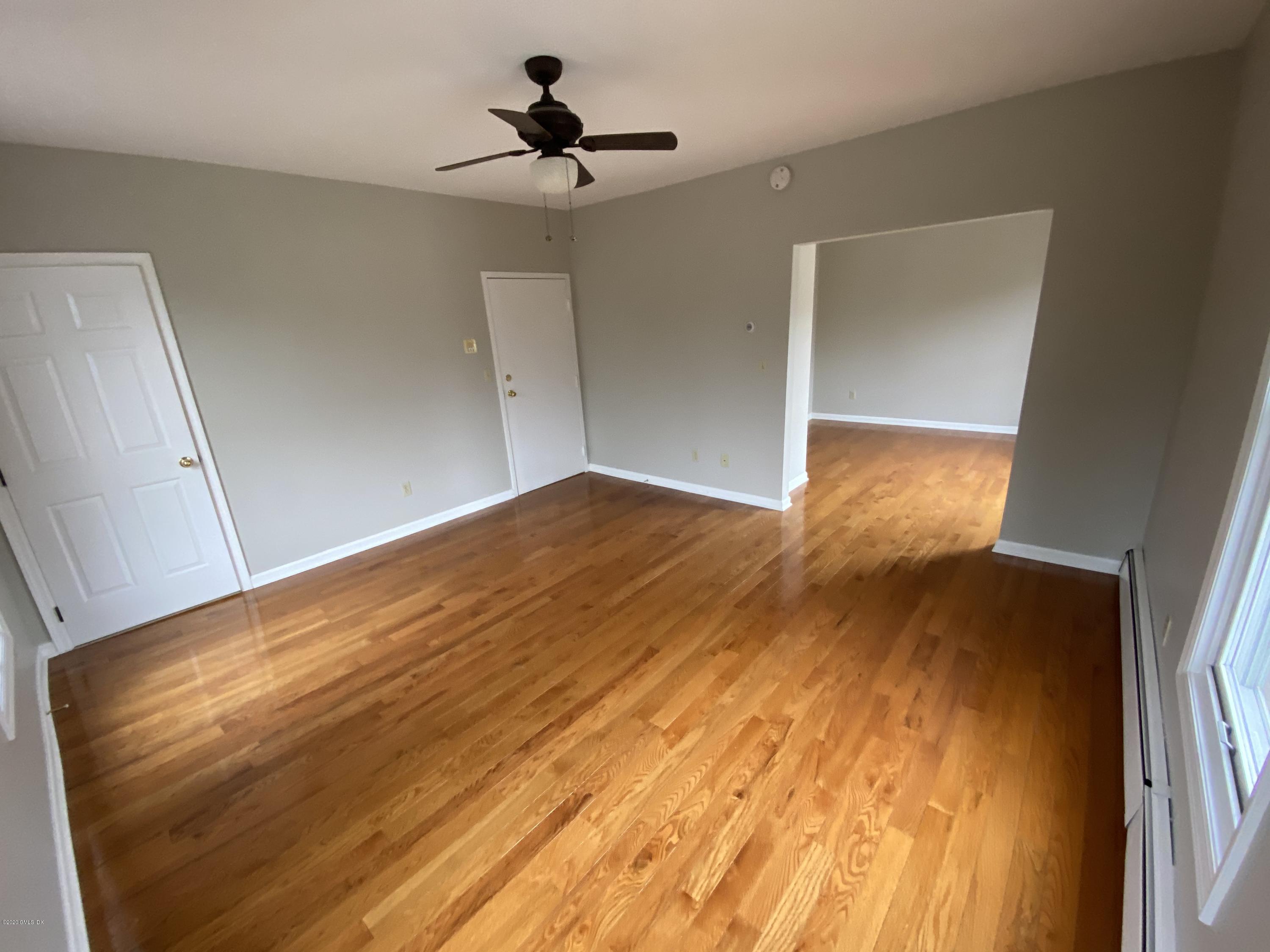 131 Mason Street, Unit 2 Greenwich, CT 06830 - Photo 4 of 14 a view of empty room with wooden floor
