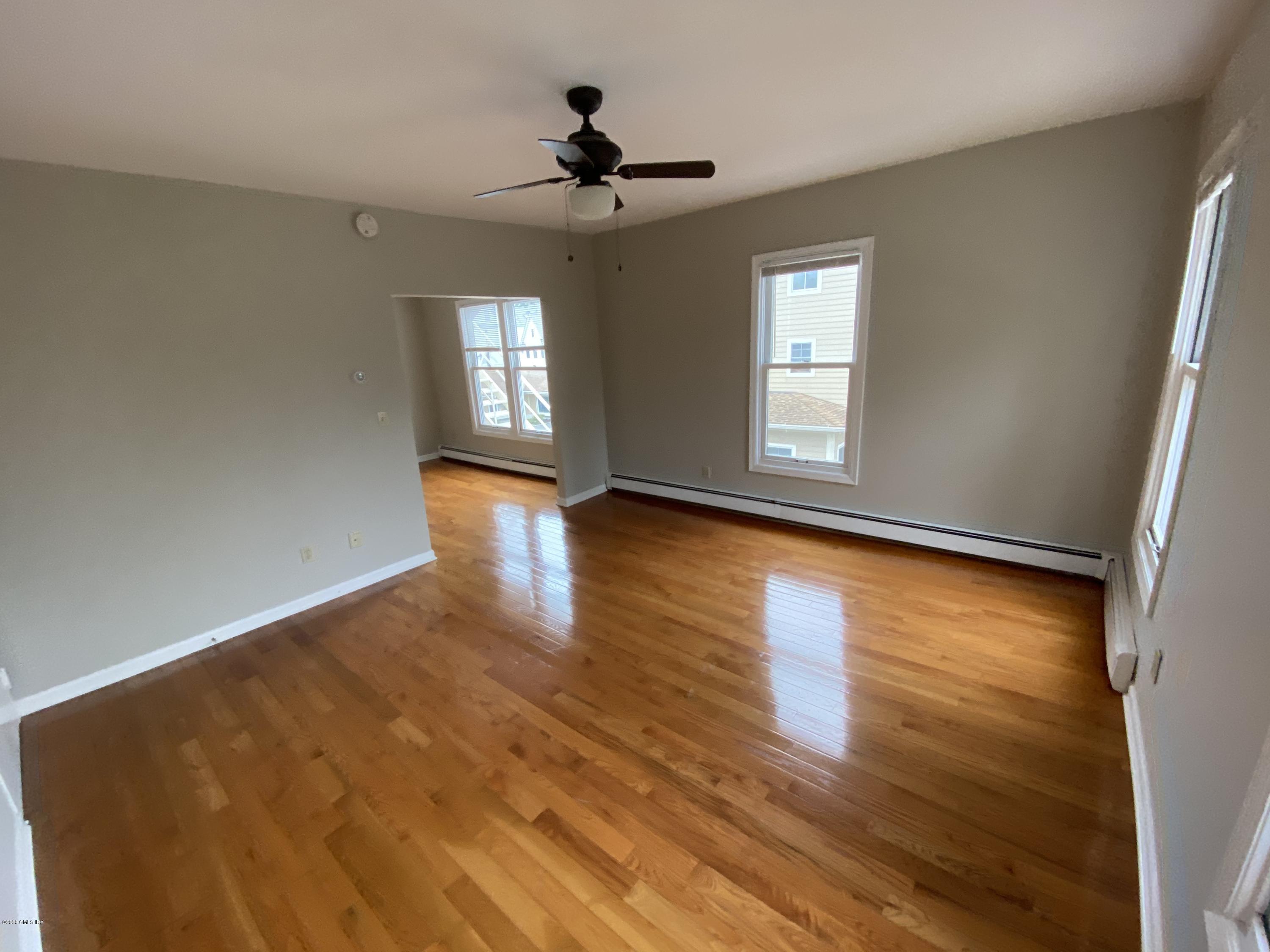 131 Mason Street, Unit 2 Greenwich, CT 06830 - Photo 5 of 14 a view of empty room with wooden floor and fan