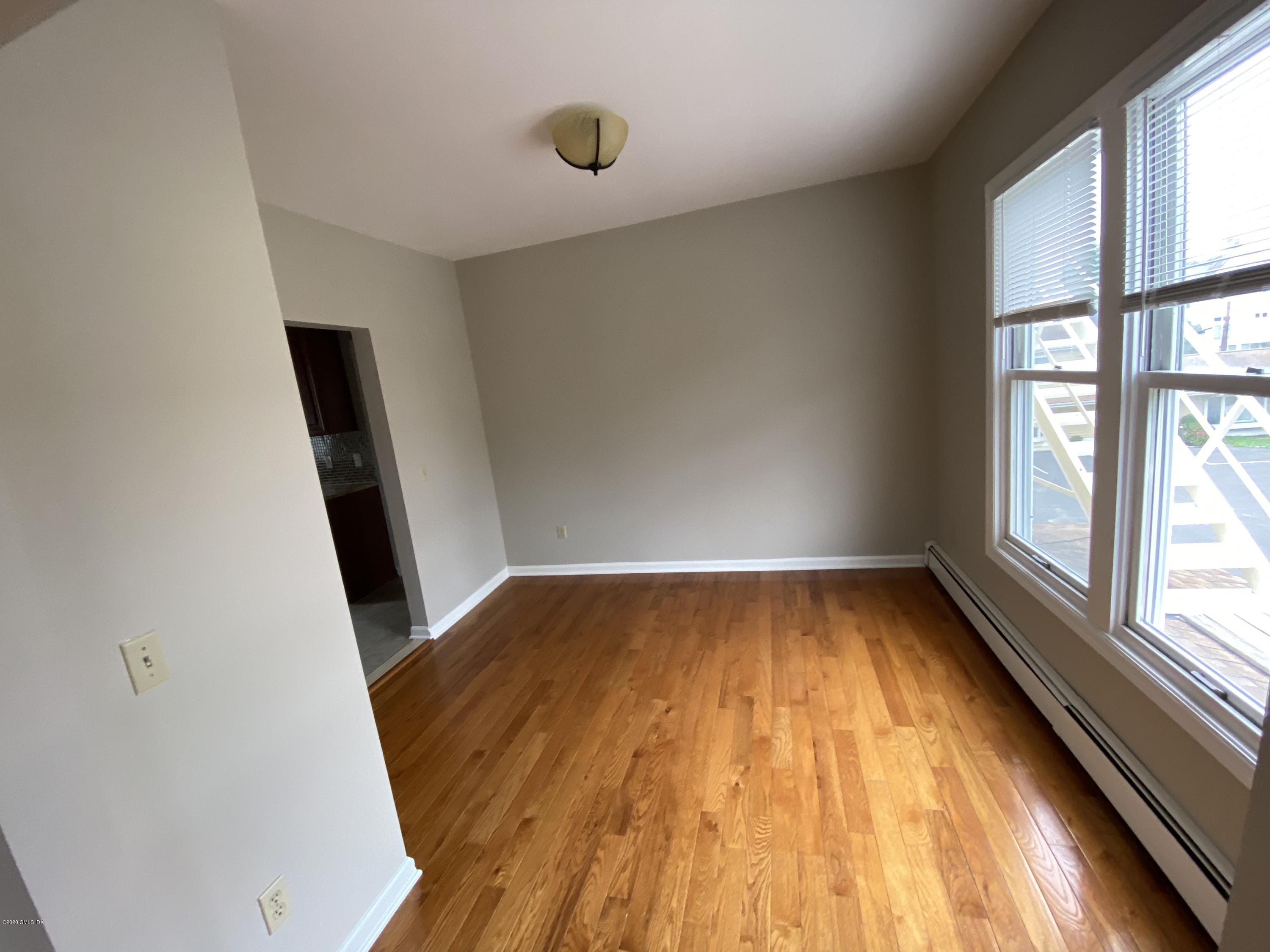 131 Mason Street, Unit 2 Greenwich, CT 06830 - Photo 6 of 14 wooden floor in an empty room with a window