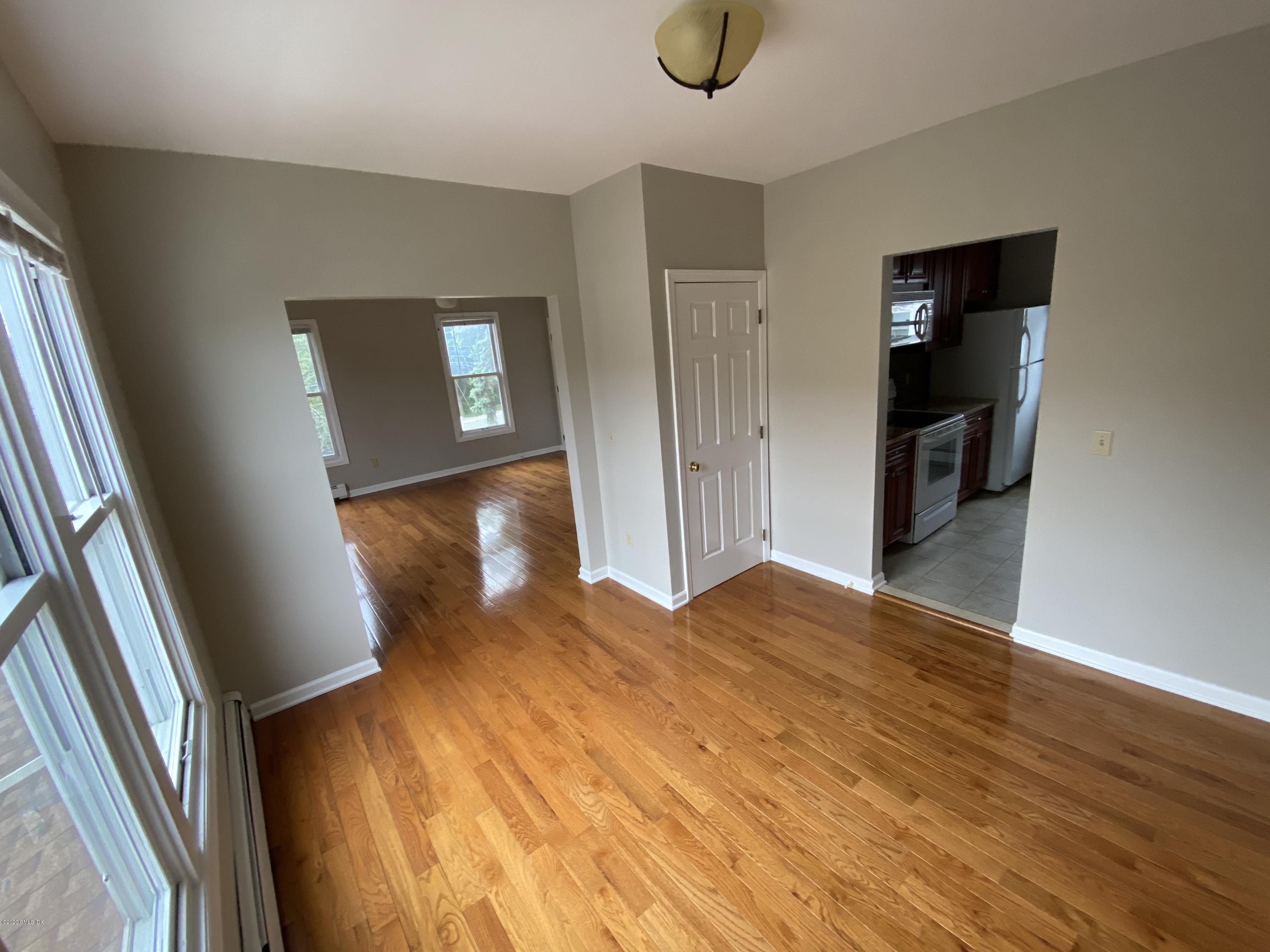 131 Mason Street, Unit 2 Greenwich, CT 06830 - Photo 7 of 14 a view of a livingroom with wooden floor and stairs