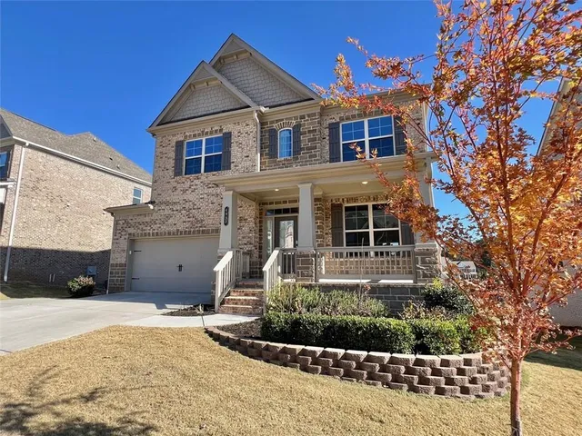 a front view of a house with a yard