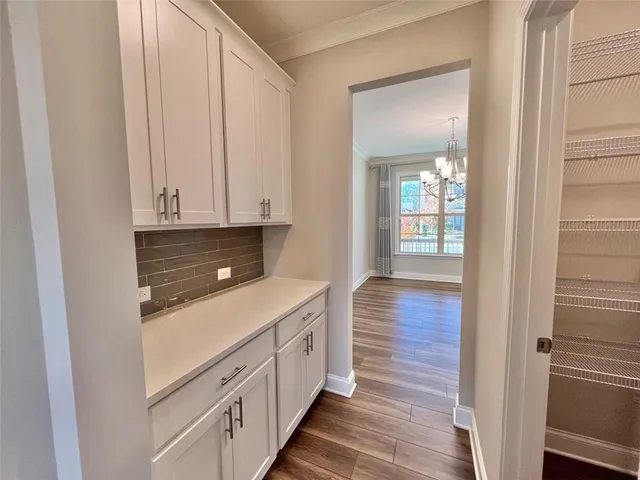 a kitchen with stainless steel appliances granite countertop a stove and a wooden floor