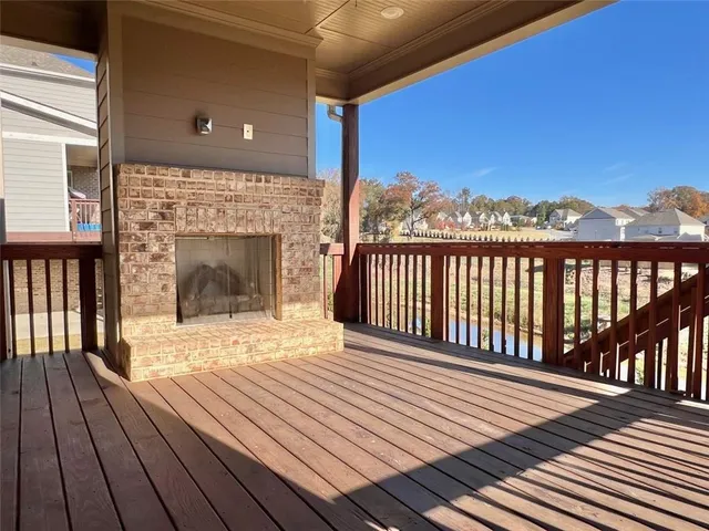 a view of a balcony with wooden floor and fence