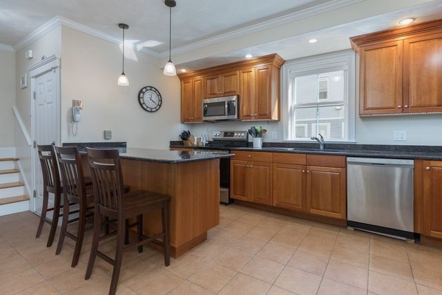 a kitchen with a sink counter top space cabinets and stainless steel appliances