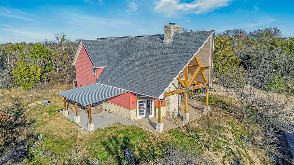6775 Silver Creek Azle Road Azle, TX 76020 - Photo 3 of 40 Back of house featuring french doors, a shingled roof, a chimney, a patio, and a yard