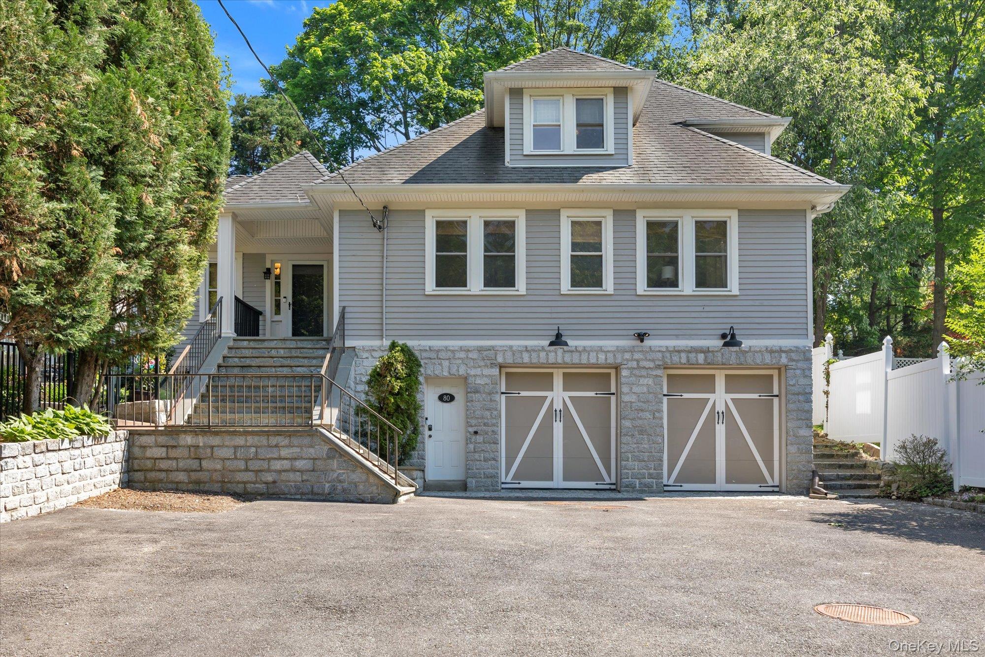 80 Skunks Misery Road Locust Valley, NY 11560 - Photo 2 of 25 a front view of a house with a garden