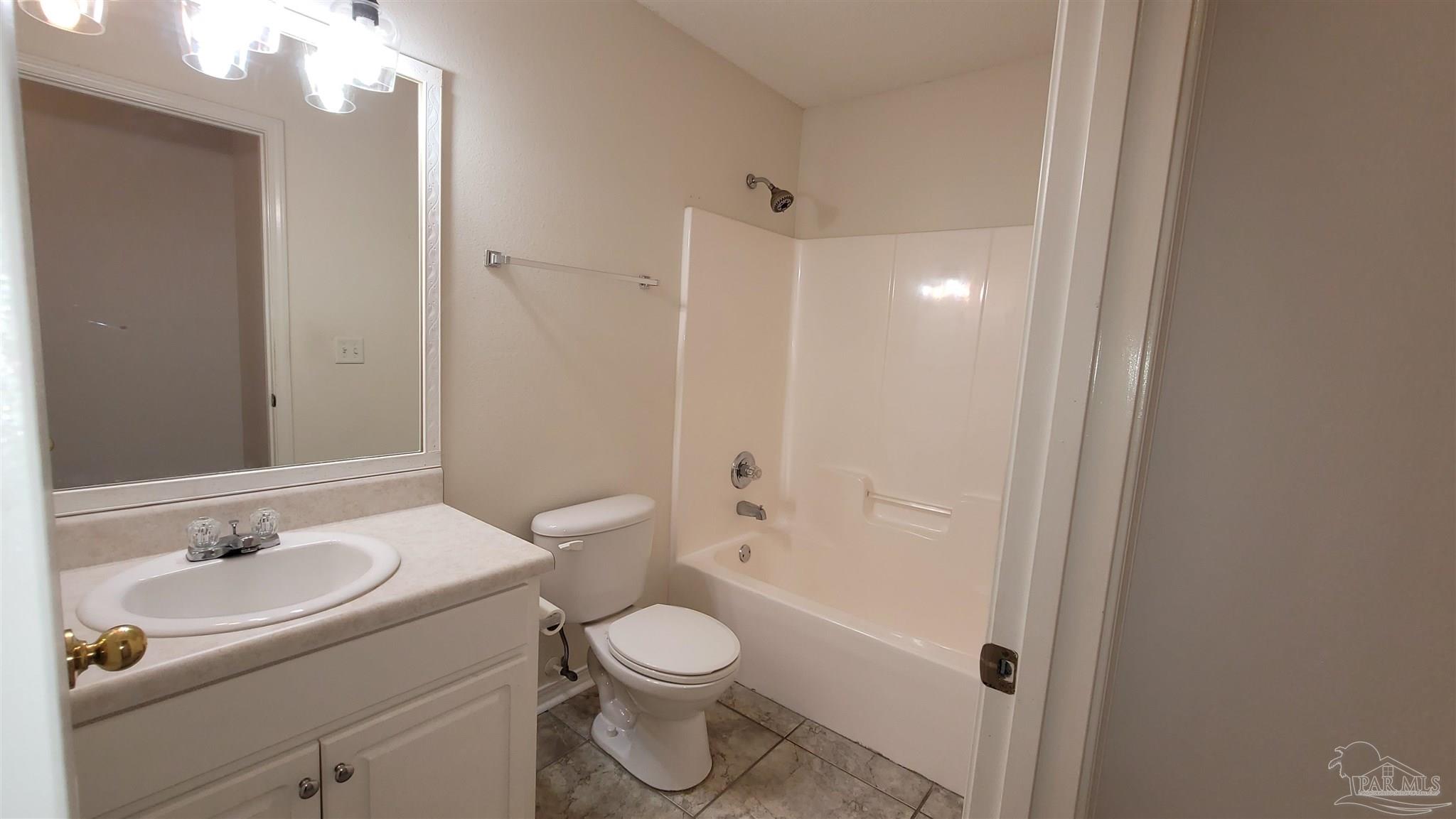 3741 Monopoly Court Gulf Breeze, FL 32563 - Photo 14 of 17 a bathroom with a sink a toilet a mirror and shower