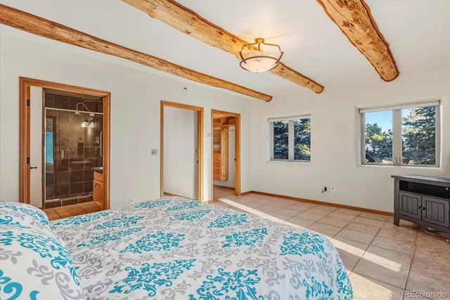 a view of a bedroom with a large bed and wooden floor