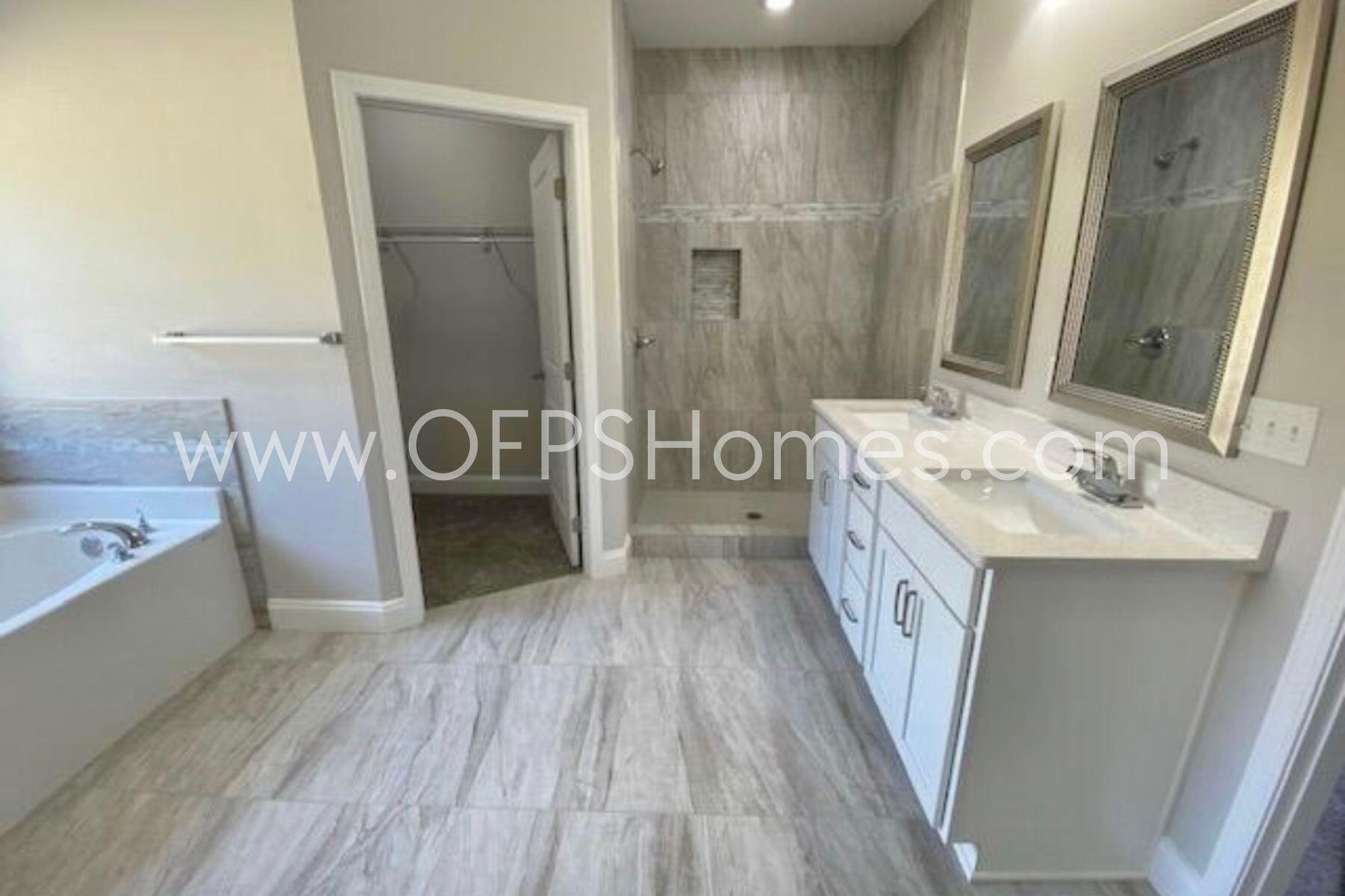 519 Friendship Road Mary Esther, FL 32569 - Photo 5 of 10 a bathroom with a double vanity sink a mirror and a bathtub