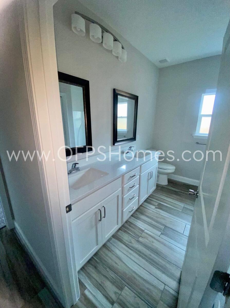 519 Friendship Road Mary Esther, FL 32569 - Photo 7 of 10 a bathroom with a double vanity sink and a mirror