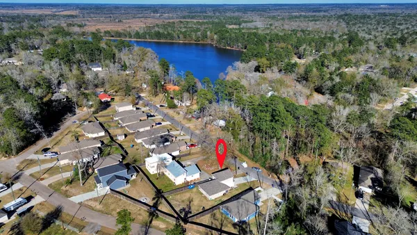 an aerial view of residential house with outdoor space and trees