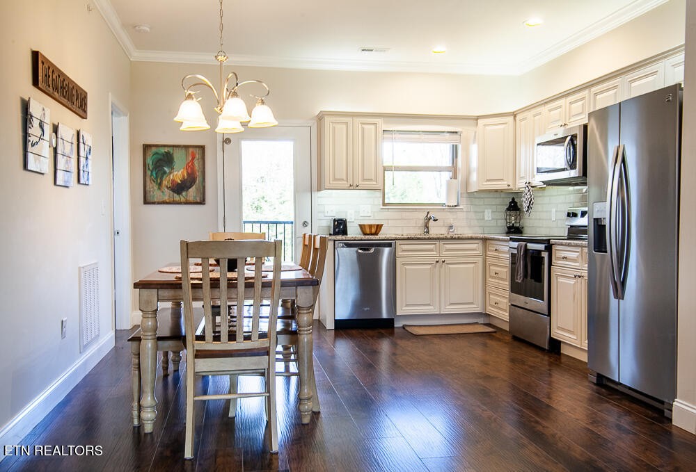 338 Shooting Star Loop, Unit 203 Townsend, TN 37882 - Photo 6 of 30 a kitchen with stainless steel appliances a dining table chairs and wooden floor