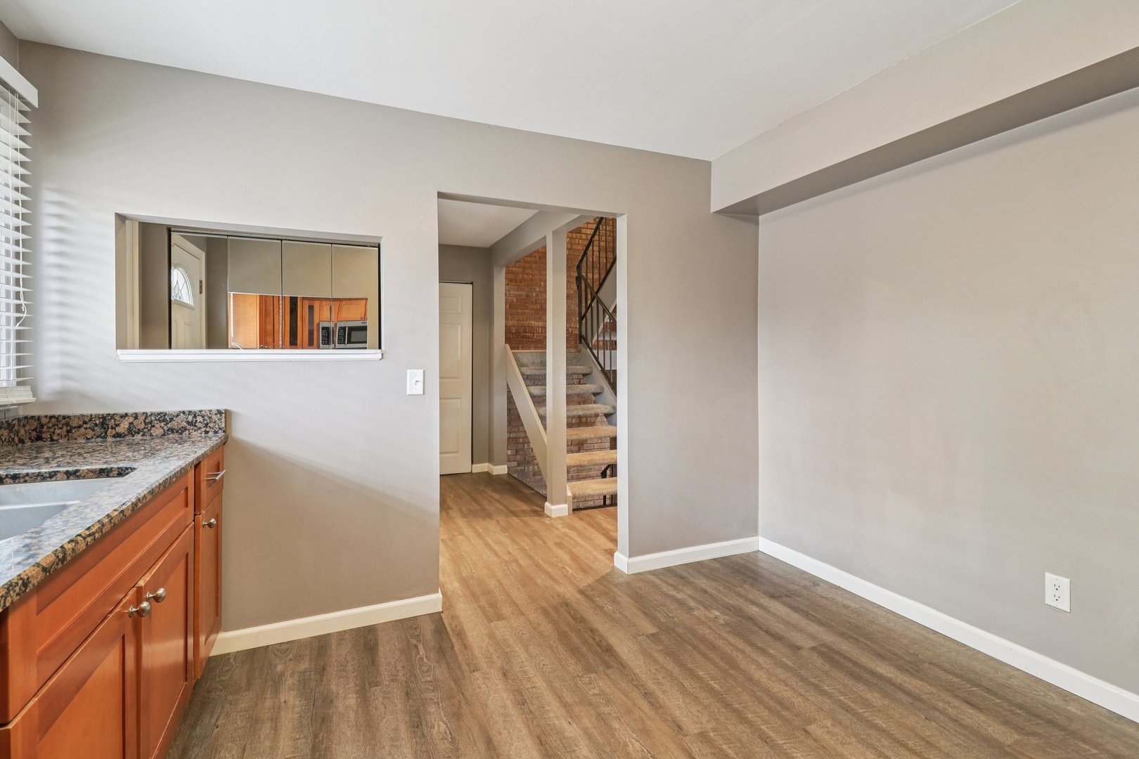 75 Mineola Road, Unit 75 Fox Lake, IL 60020 - Photo 13 of 33 a view of a kitchen with wooden floor and a sink