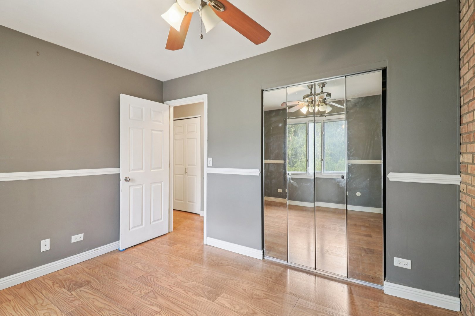 75 Mineola Road, Unit 75 Fox Lake, IL 60020 - Photo 22 of 33 wooden floor in an empty room with a mirror