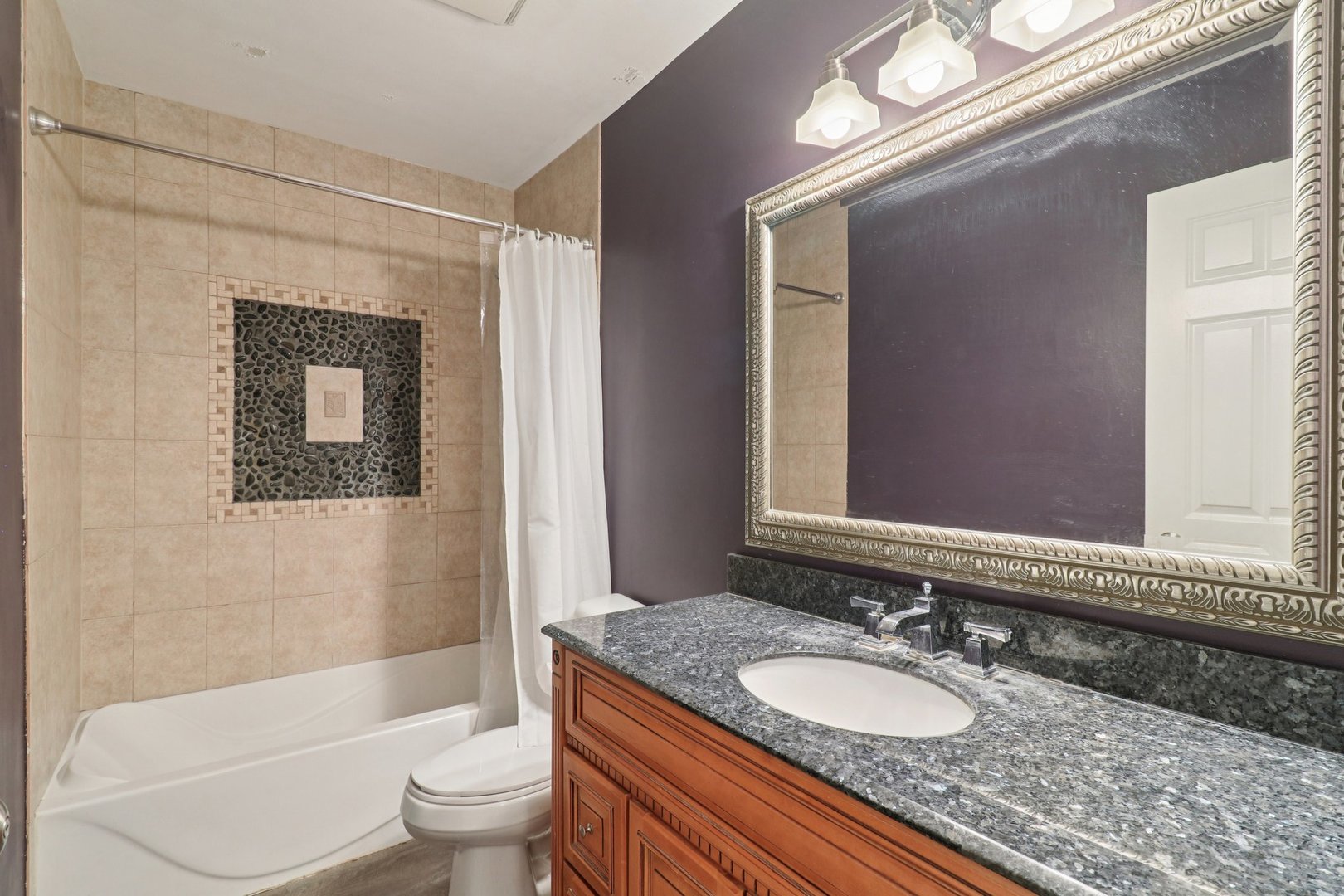 75 Mineola Road, Unit 75 Fox Lake, IL 60020 - Photo 23 of 33 a bathroom with a granite countertop sink toilet mirror and bathtub